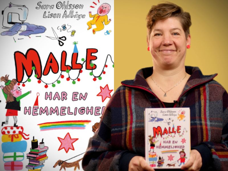 Bibliotekets børnelitteraturformidler Louise holder bogen "Malle har en hemmelighed"